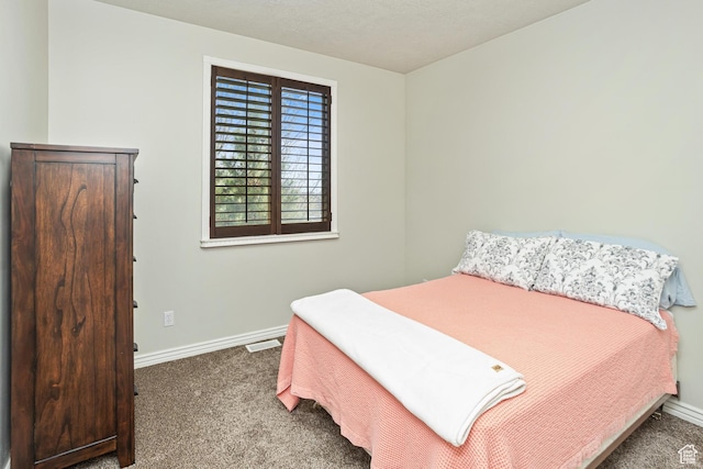 bedroom featuring baseboards, carpet flooring, and visible vents