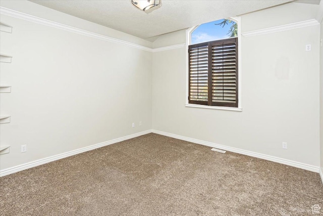 unfurnished room with visible vents, baseboards, carpet flooring, and a textured ceiling