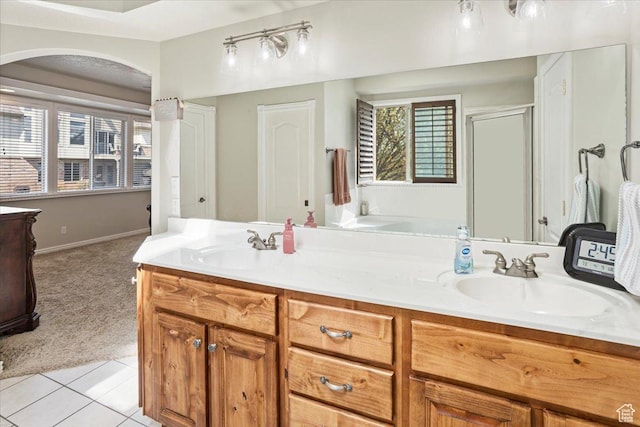 full bath featuring tile patterned floors, a shower with door, a sink, and double vanity