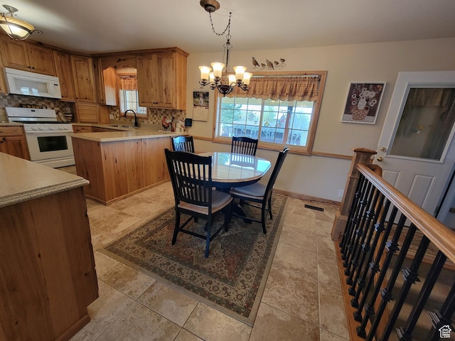 dining room with visible vents, an inviting chandelier, and a healthy amount of sunlight