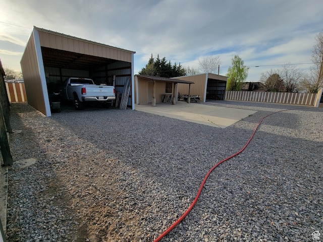 exterior space featuring fence and a carport