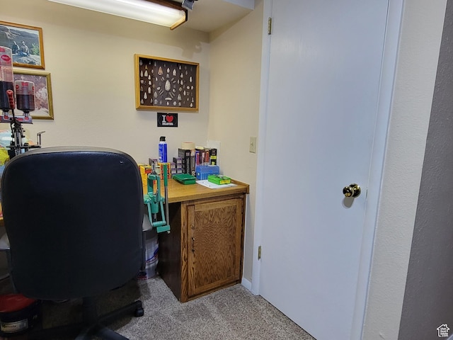 carpeted home office featuring baseboards