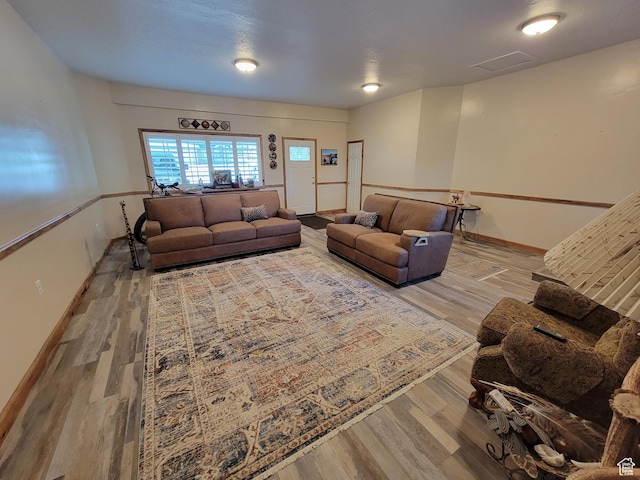 living area featuring baseboards and wood finished floors