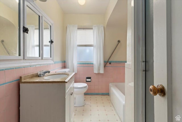 148 N 100 E, American Fork, UT 84003 - bathroom featuring tile patterned floors, wainscoting, tile walls, and toilet