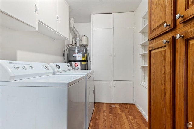 148 N 100 E, American Fork, UT 84003 - washroom with light wood-style flooring, washer and clothes dryer, cabinet space, and water heater