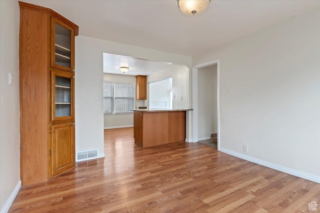 148 N 100 E, American Fork, UT 84003 - unfurnished living room featuring visible vents, baseboards, and light wood-style floors