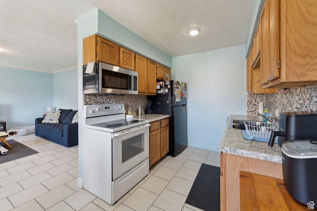 1601 W 400 S Unit 26, Salt Lake City, UT 84104 - kitchen featuring a sink, light countertops, freestanding refrigerator, white electric stove, and stainless steel microwave