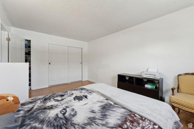 1601 W 400 S Unit 26, Salt Lake City, UT 84104 - bedroom with a closet, wood finished floors, and a textured ceiling