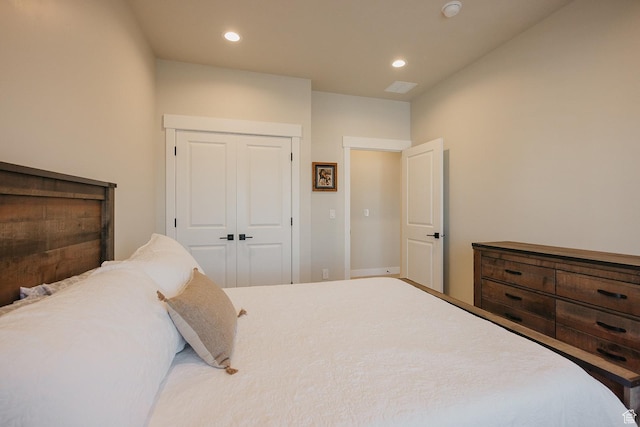 bedroom with recessed lighting and a closet