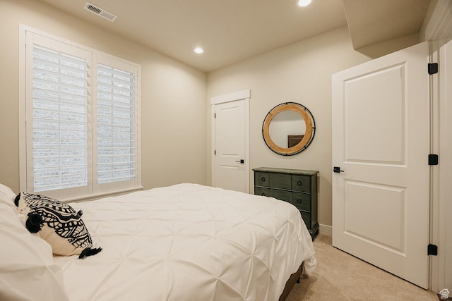 bedroom with light carpet, recessed lighting, and visible vents