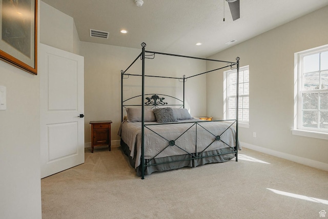 bedroom with visible vents, multiple windows, and carpet floors