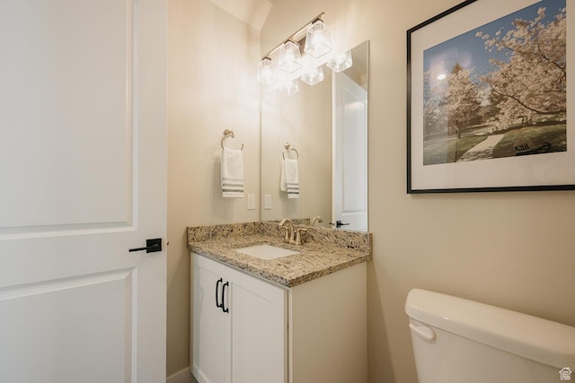 bathroom featuring toilet and vanity