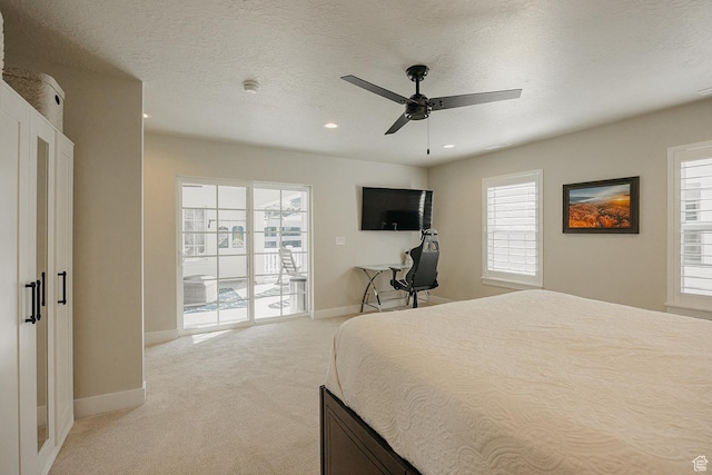 bedroom featuring baseboards, a textured ceiling, recessed lighting, access to outside, and light colored carpet