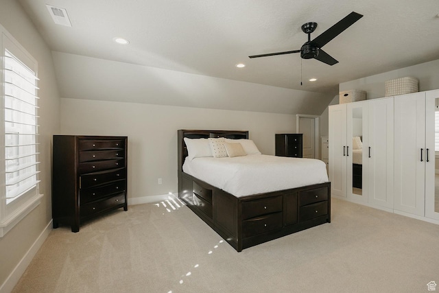 bedroom with light carpet, recessed lighting, baseboards, and lofted ceiling