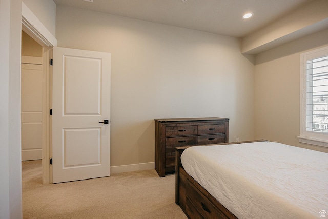 bedroom with baseboards, recessed lighting, and light colored carpet