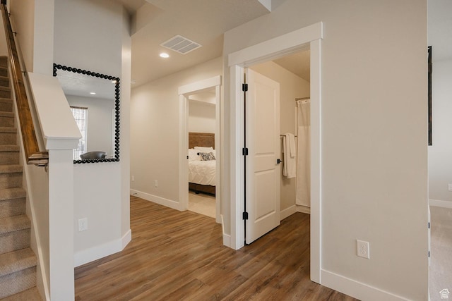 corridor featuring visible vents, recessed lighting, stairway, wood finished floors, and baseboards