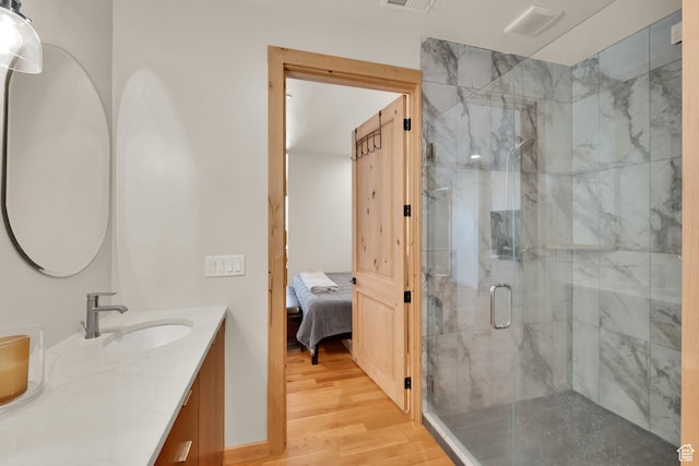 10802 E Green Briar Rd Unit 562, Heber City, UT 84032 - ensuite bathroom with vanity, ensuite bathroom, a marble finish shower, visible vents, and wood finished floors