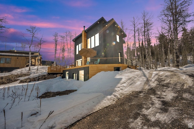 snow covered property featuring a wooden deck