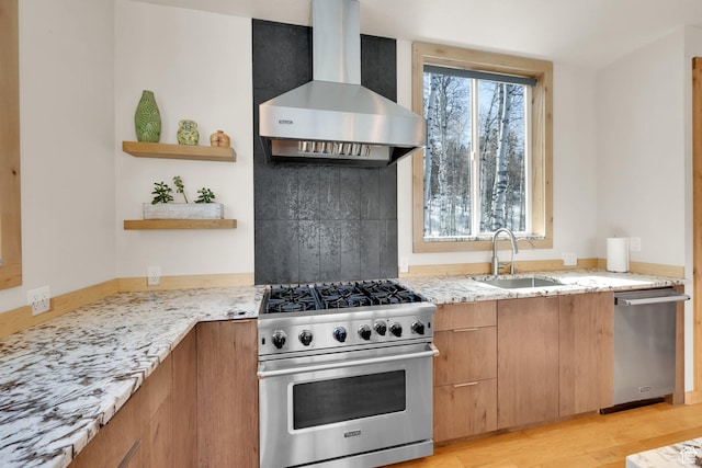 10802 E Green Briar Rd Unit 562, Heber City, UT 84032 - kitchen featuring a sink, wall chimney range hood, light wood-type flooring, light stone countertops, and stainless steel appliances