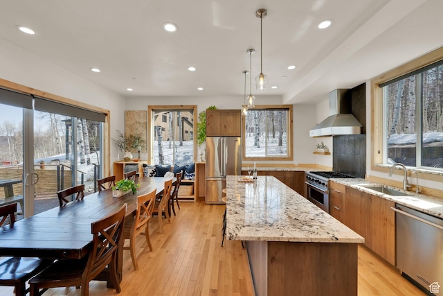 10802 E Green Briar Rd Unit 562, Heber City, UT 84032 - kitchen with an island with sink, wall chimney range hood, recessed lighting, appliances with stainless steel finishes, and a sink