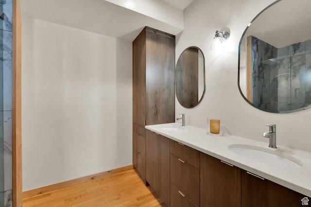 10802 E Green Briar Rd Unit 562, Heber City, UT 84032 - full bathroom featuring a sink, baseboards, double vanity, and wood finished floors