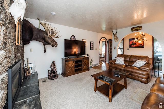 314 W 100 S, Providence, UT 84332 - carpeted living area featuring a glass covered fireplace, arched walkways, and a textured ceiling