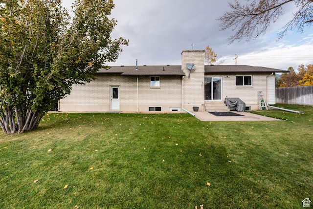 314 W 100 S, Providence, UT 84332 - rear view of house featuring a patio area, brick siding, entry steps, a yard, and fence