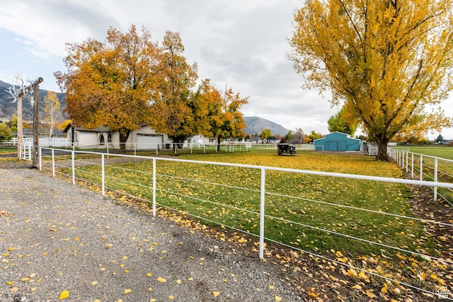 314 W 100 S, Providence, UT 84332 - view of yard featuring a mountain view, fence, and an outdoor structure