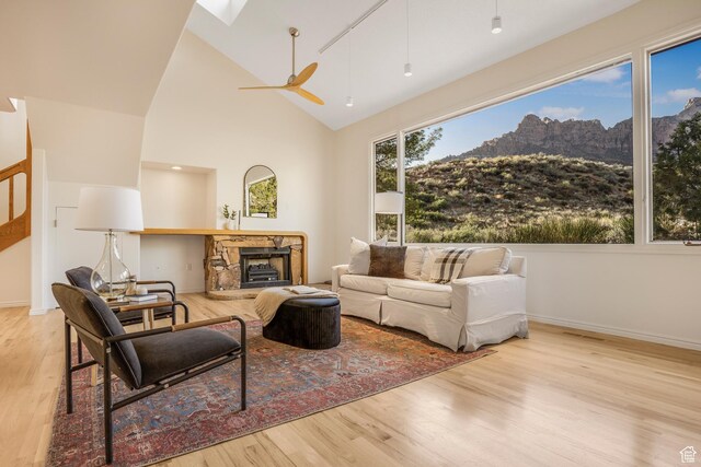 282 Valley View Dr, Springdale, UT 84767 - living area with a mountain view, a fireplace, a ceiling fan, high vaulted ceiling, and wood finished floors