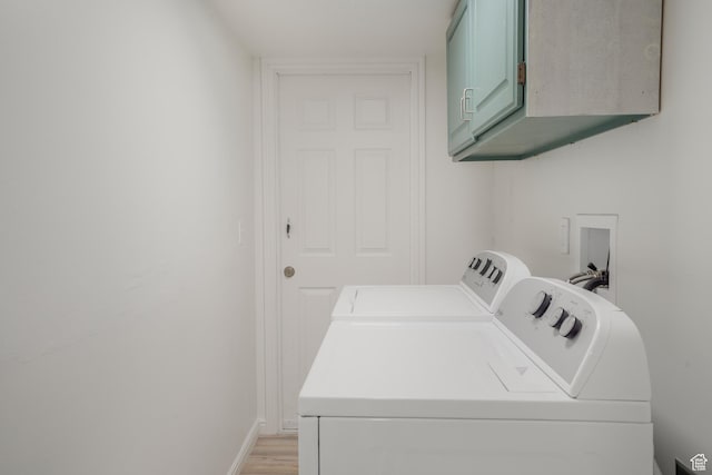 282 Valley View Dr, Springdale, UT 84767 - washroom with light wood-type flooring, washing machine and dryer, baseboards, and cabinet space