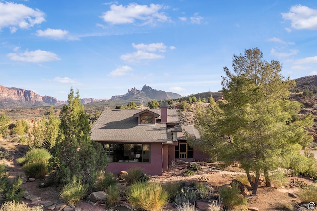 282 Valley View Dr, Springdale, UT 84767 - view of front of house featuring roof with shingles, stucco siding, a mountain view, and a chimney