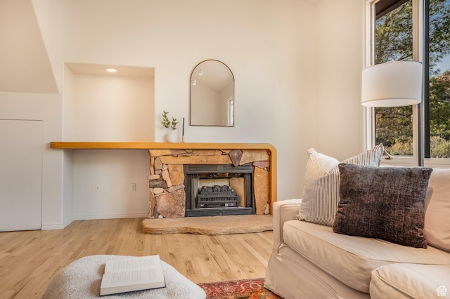 282 Valley View Dr, Springdale, UT 84767 - living area with baseboards, wood finished floors, a high ceiling, and a stone fireplace