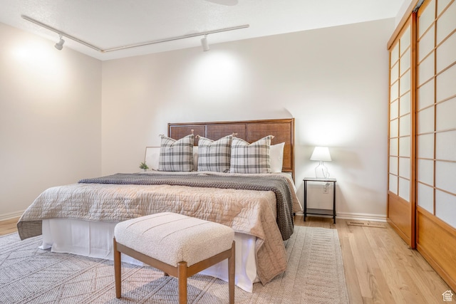 282 Valley View Dr, Springdale, UT 84767 - bedroom featuring rail lighting, baseboards, and wood finished floors
