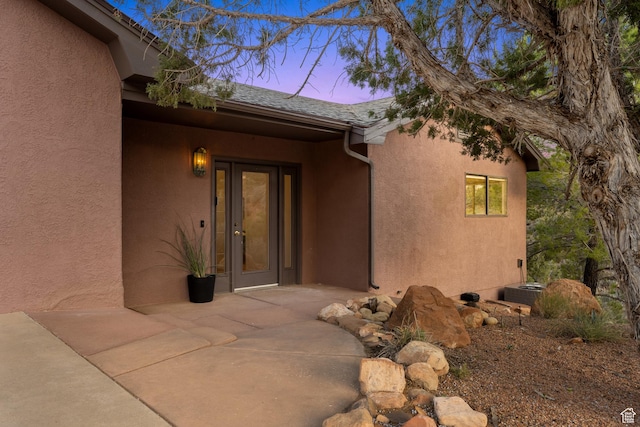282 Valley View Dr, Springdale, UT 84767 - exterior entry at dusk with stucco siding