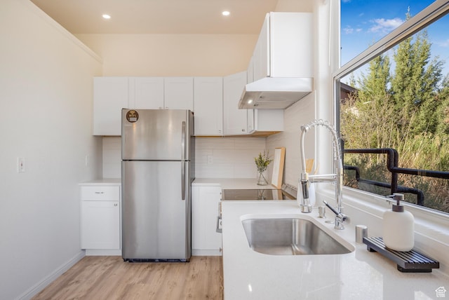 282 Valley View Dr, Springdale, UT 84767 - kitchen featuring light countertops, freestanding refrigerator, white cabinetry, wall chimney exhaust hood, and a sink