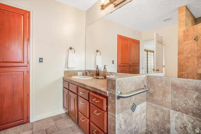 282 Valley View Dr, Springdale, UT 84767 - bathroom with vanity, baseboards, walk in shower, stone finish floor, and visible vents