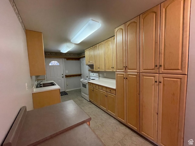 848 N 500 W, Malad City, ID 83252 - kitchen with baseboards, light countertops, white electric range, a sink, and light brown cabinetry