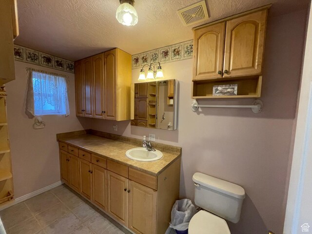848 N 500 W, Malad City, ID 83252 - bathroom featuring toilet, a textured ceiling, vanity, and visible vents