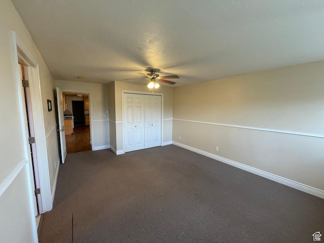 848 N 500 W, Malad City, ID 83252 - unfurnished bedroom featuring dark colored carpet, a closet, baseboards, a textured ceiling, and a ceiling fan