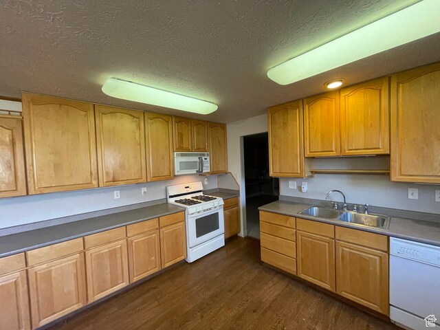 848 N 500 W, Malad City, ID 83252 - kitchen with dark wood-type flooring, white appliances, a textured ceiling, and a sink