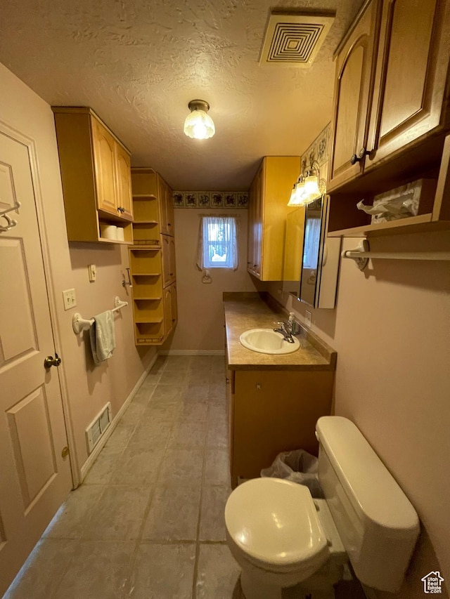 848 N 500 W, Malad City, ID 83252 - bathroom with tile patterned floors, vanity, visible vents, and toilet