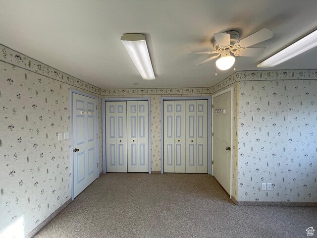 848 N 500 W, Malad City, ID 83252 - unfurnished bedroom with carpet floors, multiple closets, a ceiling fan, and wallpapered walls