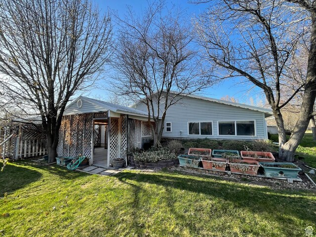 848 N 500 W, Malad City, ID 83252 - back of house with a vegetable garden and a lawn