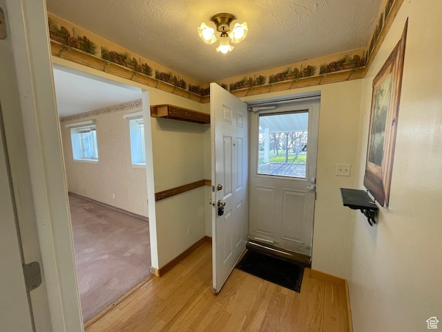 848 N 500 W, Malad City, ID 83252 - entryway with light wood-style flooring, a textured ceiling, and baseboards