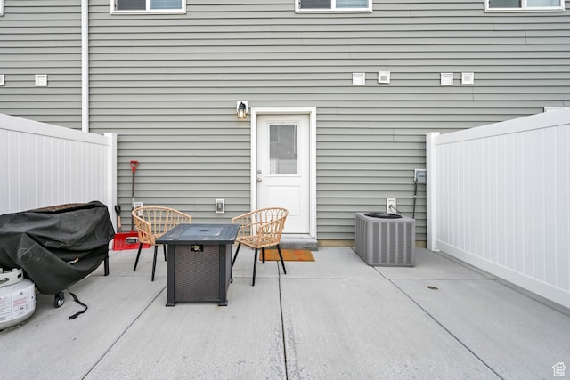 view of patio with fence and central air condition unit