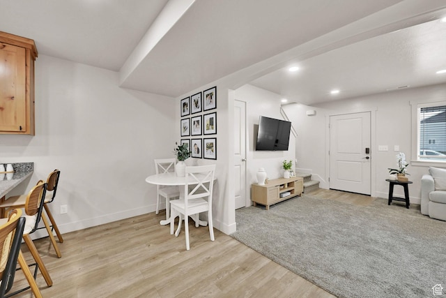 dining area featuring recessed lighting, stairs, light wood-type flooring, and baseboards