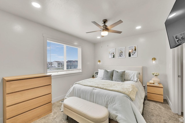 bedroom featuring recessed lighting, light colored carpet, baseboards, and ceiling fan