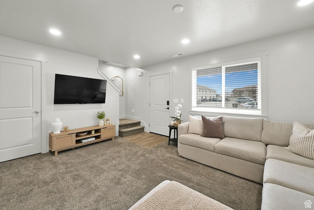 living room featuring wood finished floors, recessed lighting, visible vents, and stairway