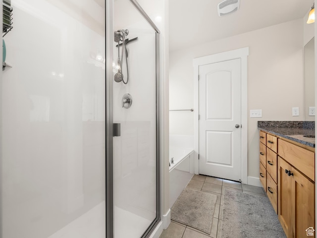 572 W Goosenest Dr, Elk Ridge, UT 84651 - full bath featuring a shower stall, tile patterned flooring, a garden tub, vanity, and baseboards