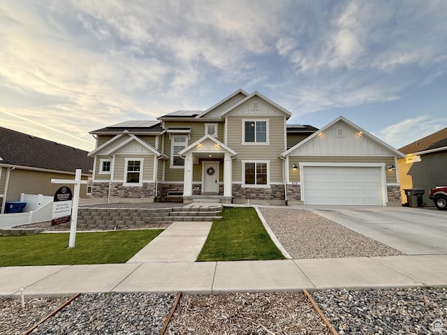 572 W Goosenest Dr, Elk Ridge, UT 84651 - craftsman inspired home with stone siding, board and batten siding, a garage, concrete driveway, and solar panels